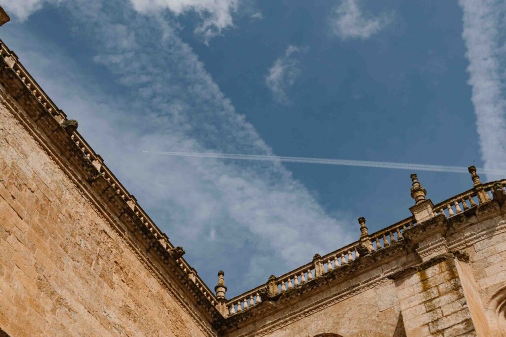 Plane traveling above an historic building in Ciudad Rodrigo in Spain.
