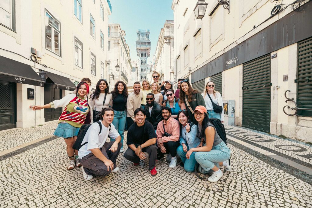 Group of young adult travelers in front of the Lisbon elevator at the base on a Contiki trip to Europe
