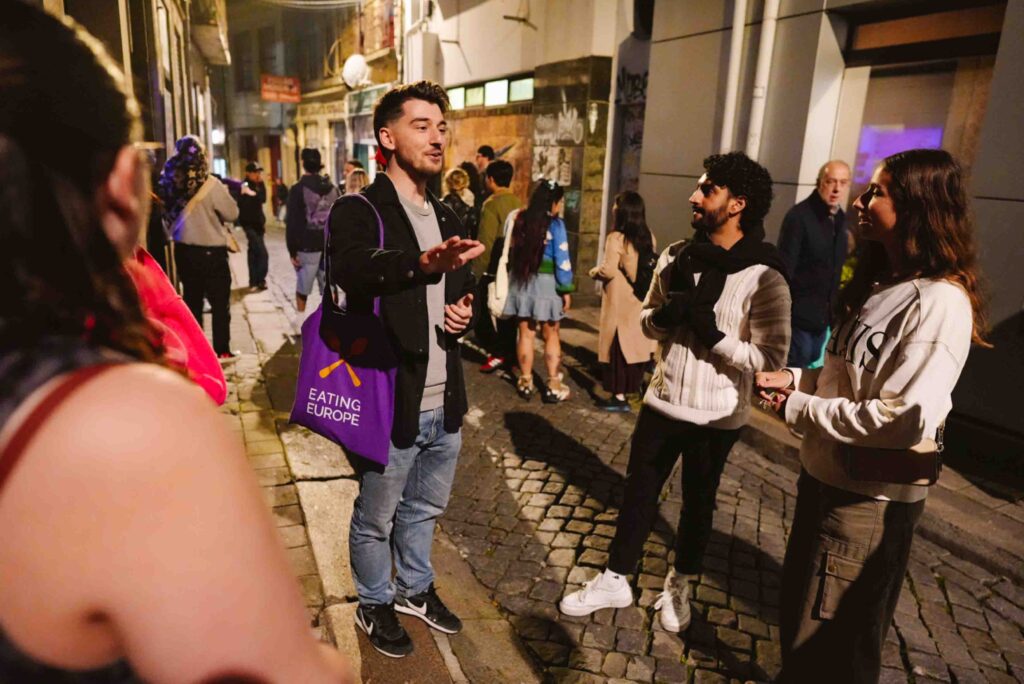 Guided food tour led by male tour guide of Eating Europe in Porto at night