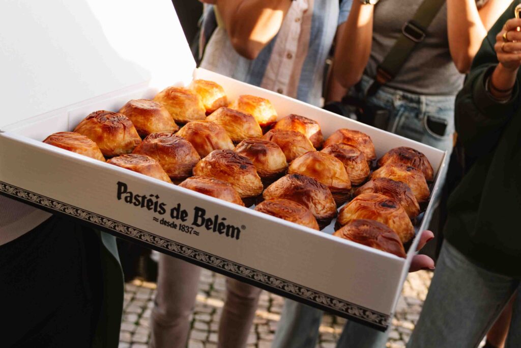 Box full of egg tarts from Pasteis de Belem in Lisbon, Portugal