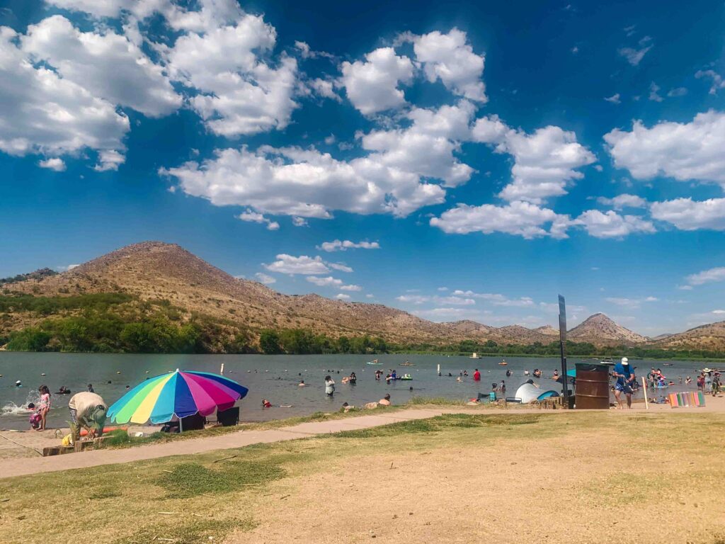 Patagonia Lake State Park in Arizona during the summer with people in and out of the water on a hot day