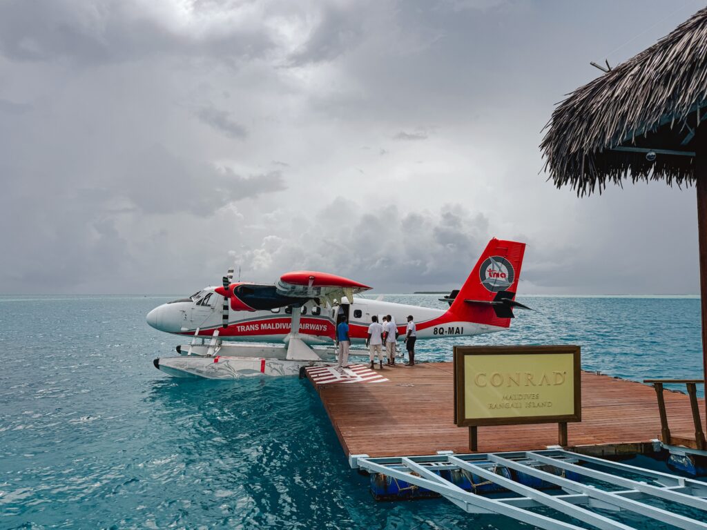 Conrad Maldives Seaplane docked at the drop off terminal on water