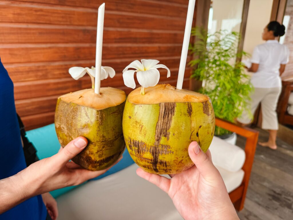 Welcome drinks from coconut with flower on top, just one of the incredible acts of service from the Conrad hotel in the Maldives