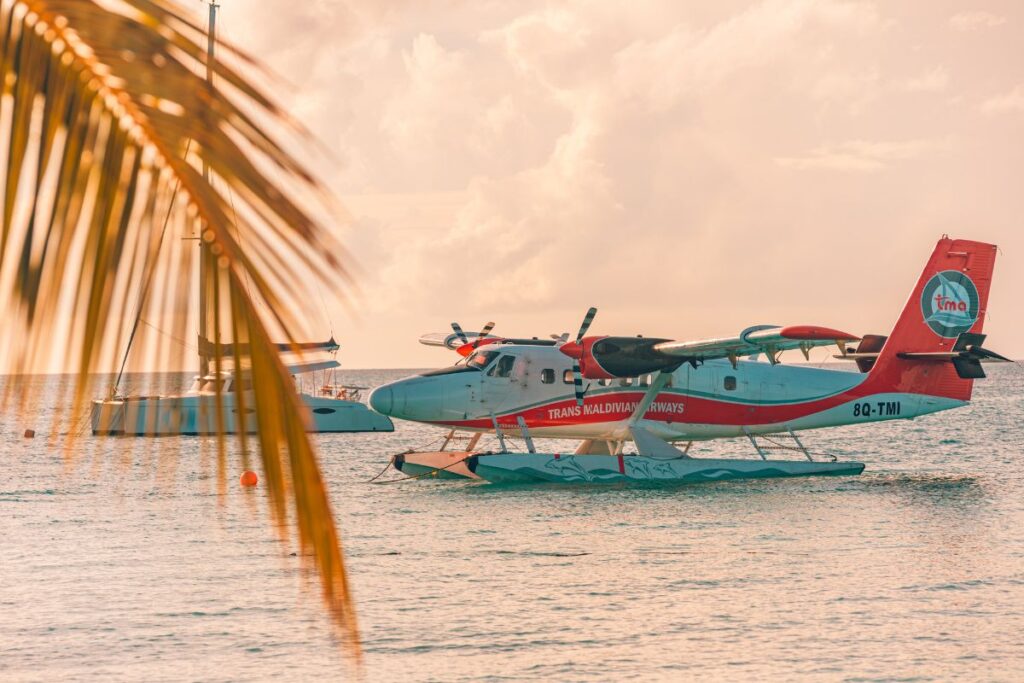Seaplane docked in the Maldives on the water during sunset